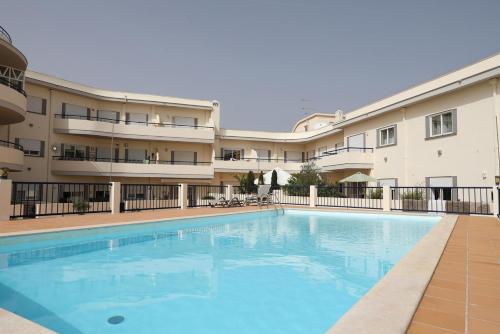 a large swimming pool in front of a building at C19 - Do Mar Apartment in Lagos in Lagos