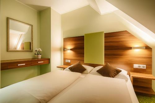 a bedroom with a bed and a mirror at Ferenc Hotel Budapest in Budapest