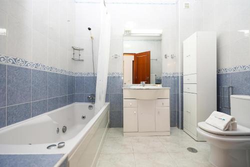 a bathroom with a tub and a toilet and a sink at C19 - Do Mar Apartment in Lagos in Lagos
