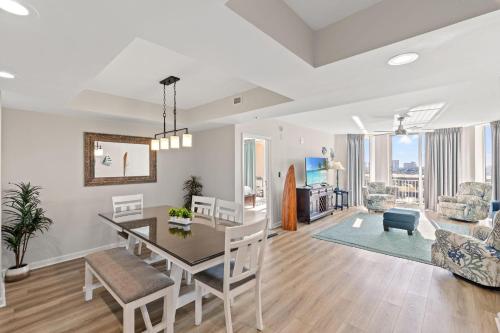 a dining room and living room with a table and chairs at Barefoot Resort - North Tower 905 - Windy Hill in Myrtle Beach