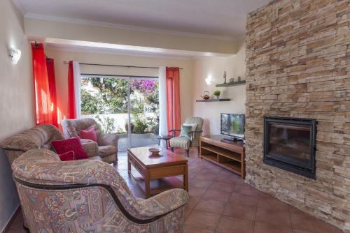 a living room with a fireplace and a tv at D07 - Torraltinha Villa in Lagos in Lagos