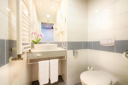 a white bathroom with a sink and a toilet at CZECH INN Hotel Ferenc in Budapest