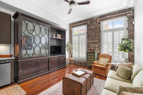 a living room with a brick wall at Knockout Loft- Near Plant Riverside in Savannah