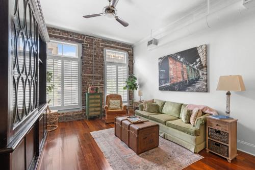 a living room with a couch and a tv at Knockout Loft- Near Plant Riverside in Savannah