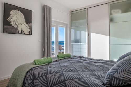 a bedroom with a bed with a view of the ocean at FozPanoramic in Foz do Arelho