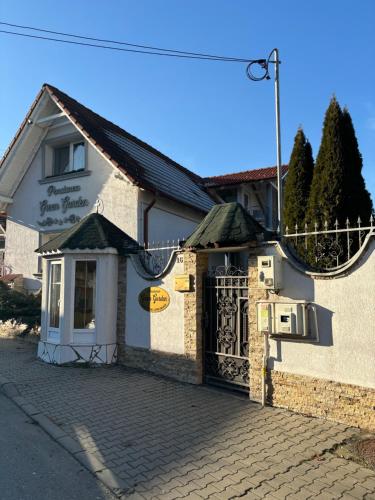 a building with a gate in front of it at Green Garden Avrig in Avrig