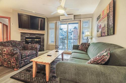 a living room with a couch and a table at Cozy 2BR-5BD Suite - Mountain Views - Htd Parking in Canmore