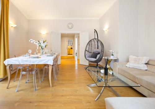 a living room with a table and a couch at Private Oxford Street Luxe Apartment in London