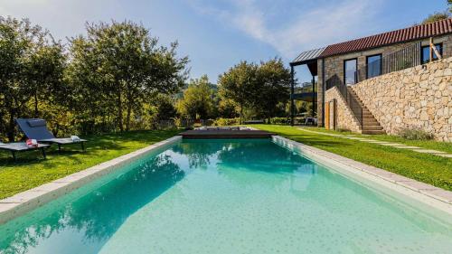 a swimming pool in the yard of a house at Quinta da Lameirinha Douro, Boutique Home - Heated Pool and Jacuzzi in Baião