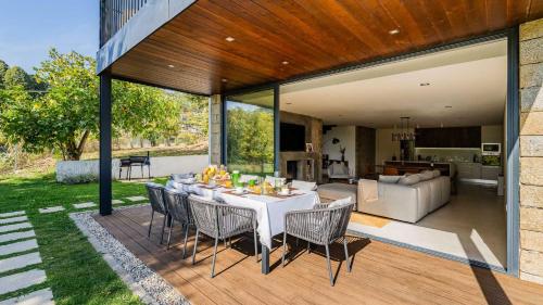 a patio with a table and chairs on a deck at Quinta da Lameirinha Douro, Boutique Home - Heated Pool and Jacuzzi in Baião