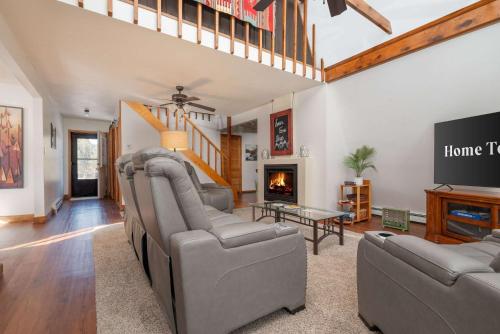 a living room with two couches and a tv at Rustic Mountain Getaway~Golf~Skiing~Hiking in Angel Fire
