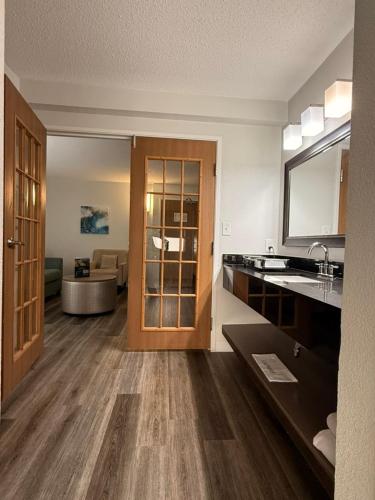 a kitchen with a sink and a living room at Hotel Wave at Rehoboth Beach in Rehoboth Beach