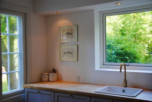 a kitchen with a sink and a window at Villa Hjortekær in Kongens Lyngby