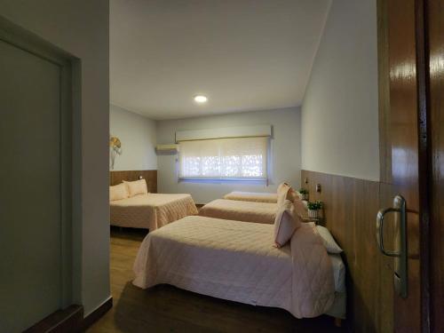 a bedroom with two beds and a window at Alas Hotel in San Rafael