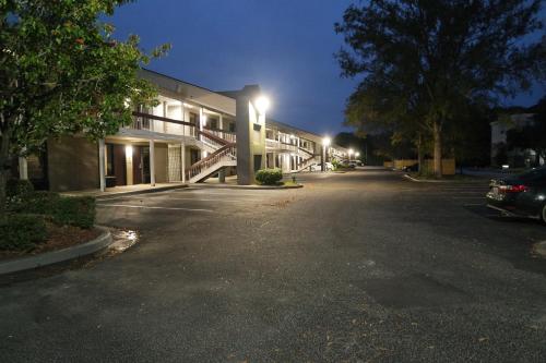 an empty street in front of a building at night at Travelodge by Wyndham North Charleston in Charleston