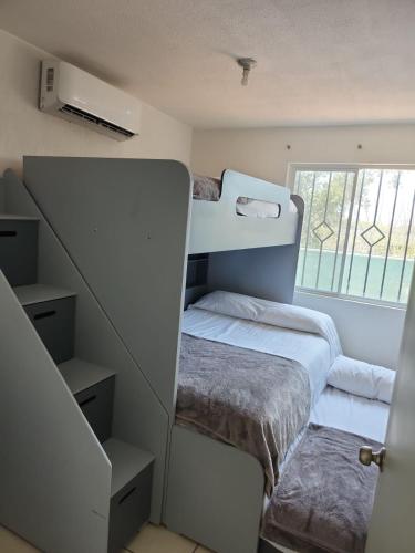 two bunk beds in a room with a window at Casa Lisboa in Puerto Vallarta