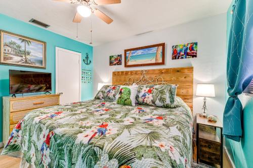 a bedroom with a bed with a tropical bedspread at Pet-Friendly Bradenton Home 1.5 Mi to Cortez Beach in Bradenton