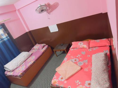 a small room with two beds and a fan at new hotel gaule in Bālāju