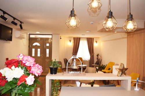 ein Wohnzimmer mit einem Tisch mit Blumen und Lampen in der Unterkunft Villa Nika Pestani in Peštani