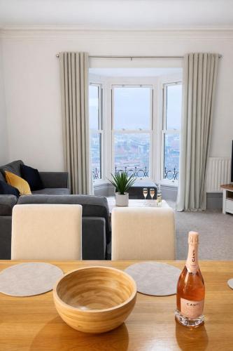 a living room with a bottle of wine on a table at Premium 3BR Penthouse Corporate Stay Parking Sleeps 6 in Lincoln