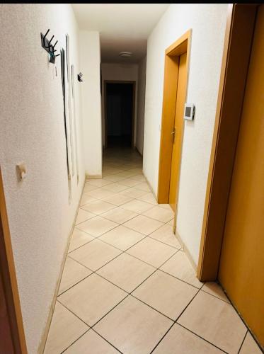 a hallway with a tile floor in a room at House AL11 in Raunheim
