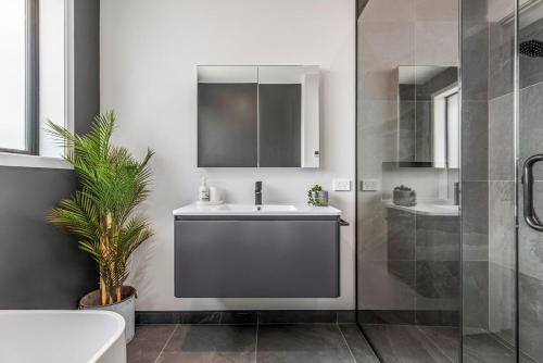 a bathroom with a sink and a shower at Luxury Hāwea, Alfresco Retreat, Sleeps 6 in Lake Hāwea