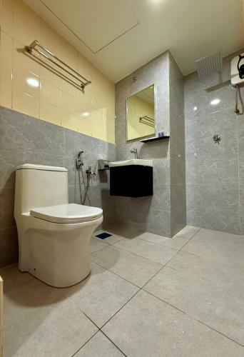 a bathroom with a toilet and a sink at Hotel Putra Hills at WTCKL in Kuala Lumpur