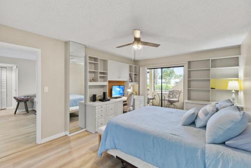 a bedroom with a bed and a television in it at IMG Condo Near Golf Course in Bradenton