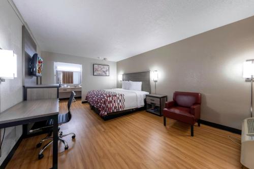 a hotel room with a bed and a desk at Red Roof Inn Charlottesville in Charlottesville