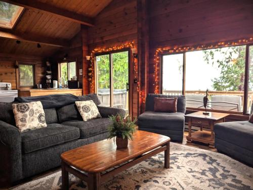 a living room with a couch and a table at Sq Bayside Cedars in Sequim