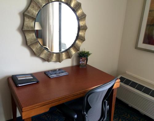 a desk in a room with a mirror on the wall at Hotel Tybee in Tybee Island