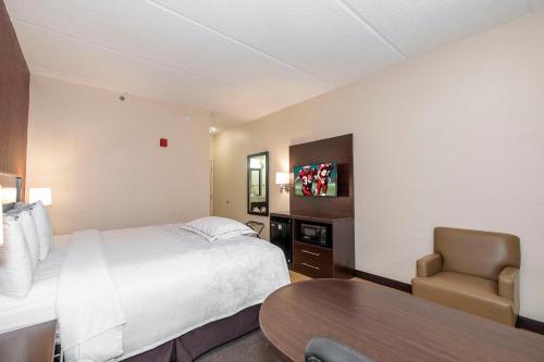 a hotel room with a bed and a table at Red Roof Inn PLUS+ San Antonio Downtown - Riverwalk in San Antonio