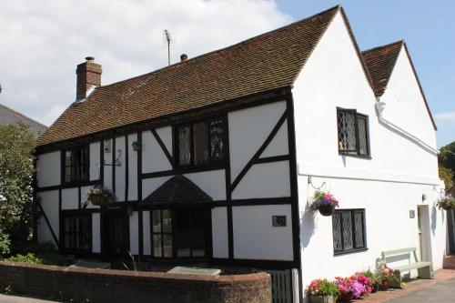 an old white and black house with black windows at B&B South Downs Way in Poynings