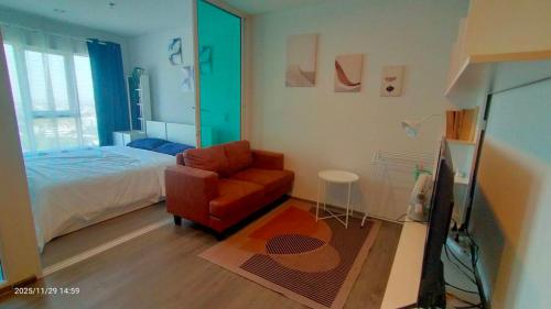 a bedroom with a bed and a red chair at "Life city 1" Apartment 300 meters from BTS in Bang Chak