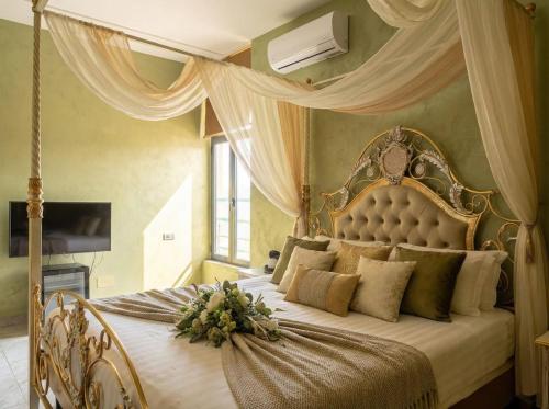 a bedroom with a canopy bed with flowers on it at Urban Artist in Tirana