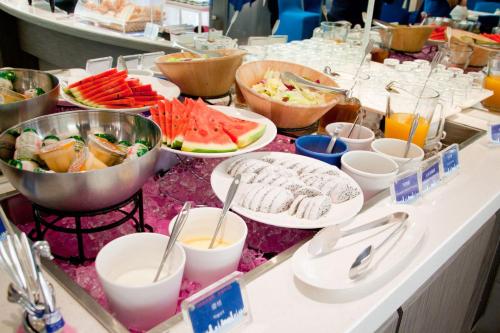 a buffet with plates of food on a table at Holiday Inn Express Taoyuan by IHG in Taoyuan