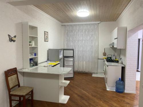 a kitchen with a counter and a table in a room at Дом в Гусаре in Qusar