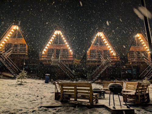 a group of chairs and lights in the snow at Tuyo cottages Gudauri in Gudauri