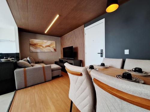 a living room with a table and a couch at LK Barro Preto 16 in Belo Horizonte