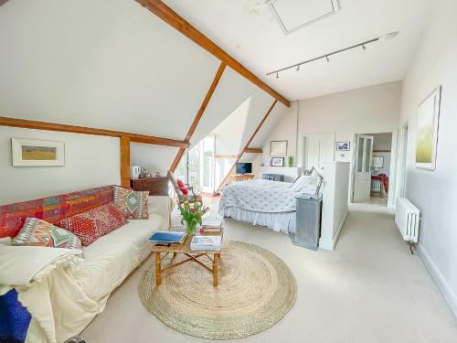 a living room with a couch and a bed at The Clock Tower in Daventry