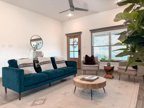 ein Wohnzimmer mit einem blauen Sofa und einem Tisch in der Unterkunft Beautiful 3BD 2B - Weatherford - Same Day Bookings in Weatherford
