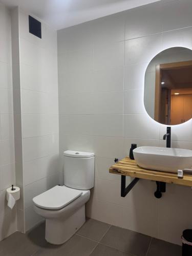 a bathroom with a toilet and a sink at El Sueño de Albarracin III in Albarracín