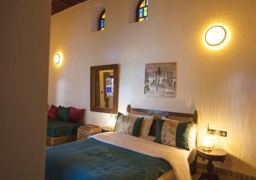 a bedroom with a bed and a couch at Riad Ruh Fes in Fez
