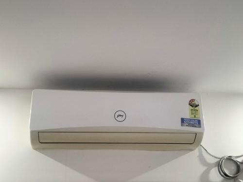 Un electrodoméstico blanco colocado encima de un mostrador. en MeDa-Frin's Hotel, en Chennai