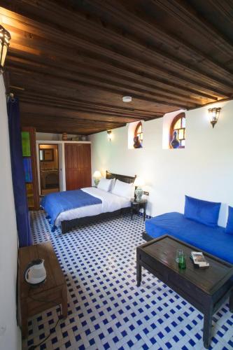 a bedroom with two beds and a coffee table at Riad Ruh Fes in Fez