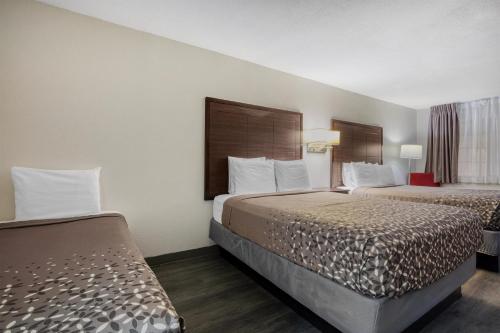a hotel room with two beds and a window at SureStay Hotel by Best Western Terrell in Terrell