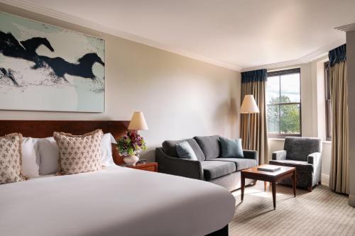 a hotel room with a large bed and a couch at Rookery Hall Hotel & Spa in Nantwich