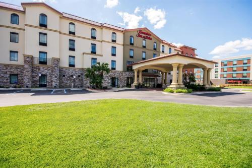 a hotel with a gazebo in front of a building at Hampton Inn & Suites Pensacola/I-10 Pine Forest Road in Pensacola