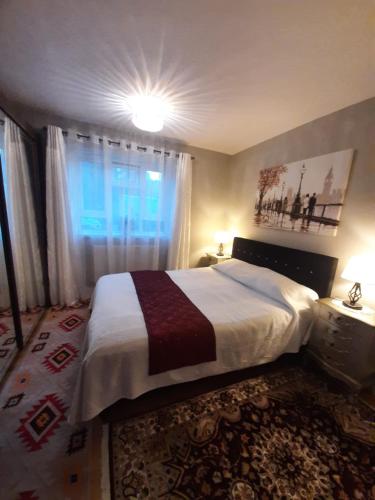 a bedroom with a large bed and a window at Greenwich Haven, London in London
