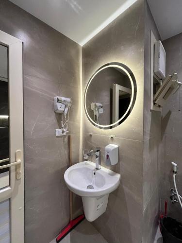 a bathroom with a sink and a mirror at Lovely Rivera Room with Breakfast in Cairo